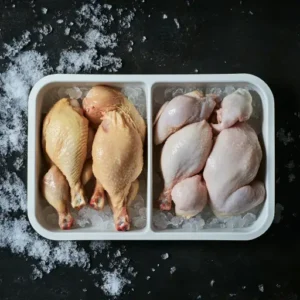 Side-by-side comparison of fresh and frozen chicken on a wooden cutting board.